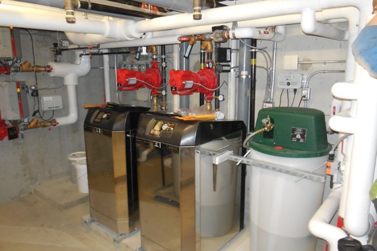 Mechanical room with condensing boilers, circulator pumps and piping